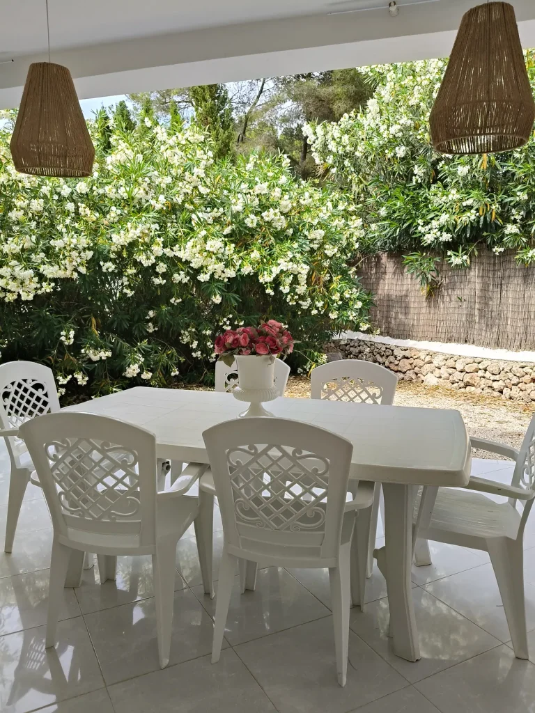 Table ombragée face au jardin fleuri